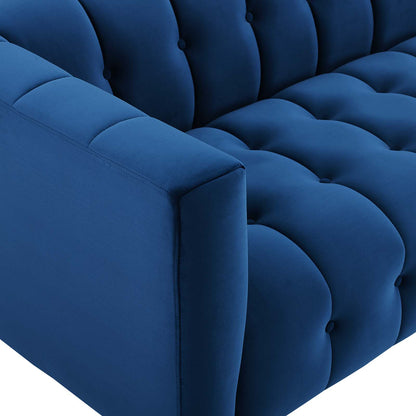 Navy blue velvet tufted sofa with square armrest and deep button cushions.