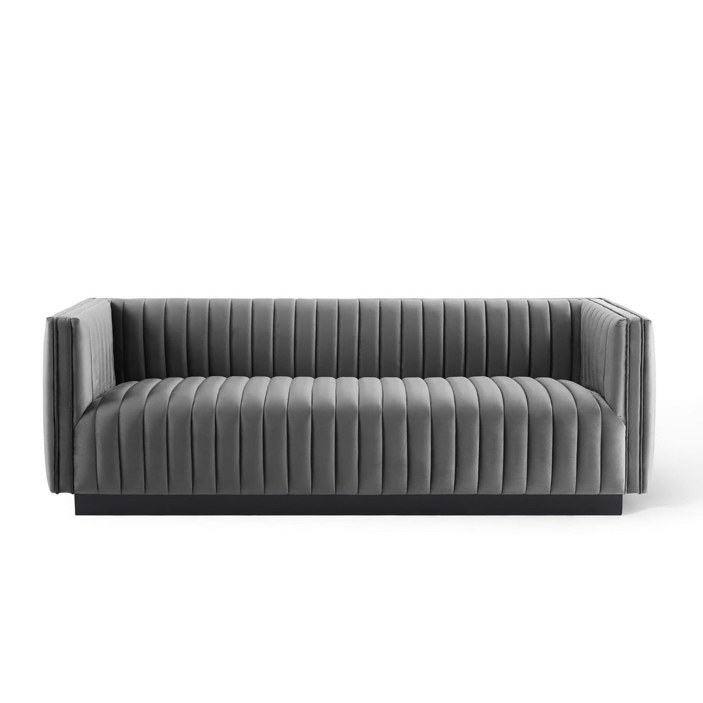 Grey velvet sofa with vertical channel tufting, low-profile arms and sleek contemporary lounge design.