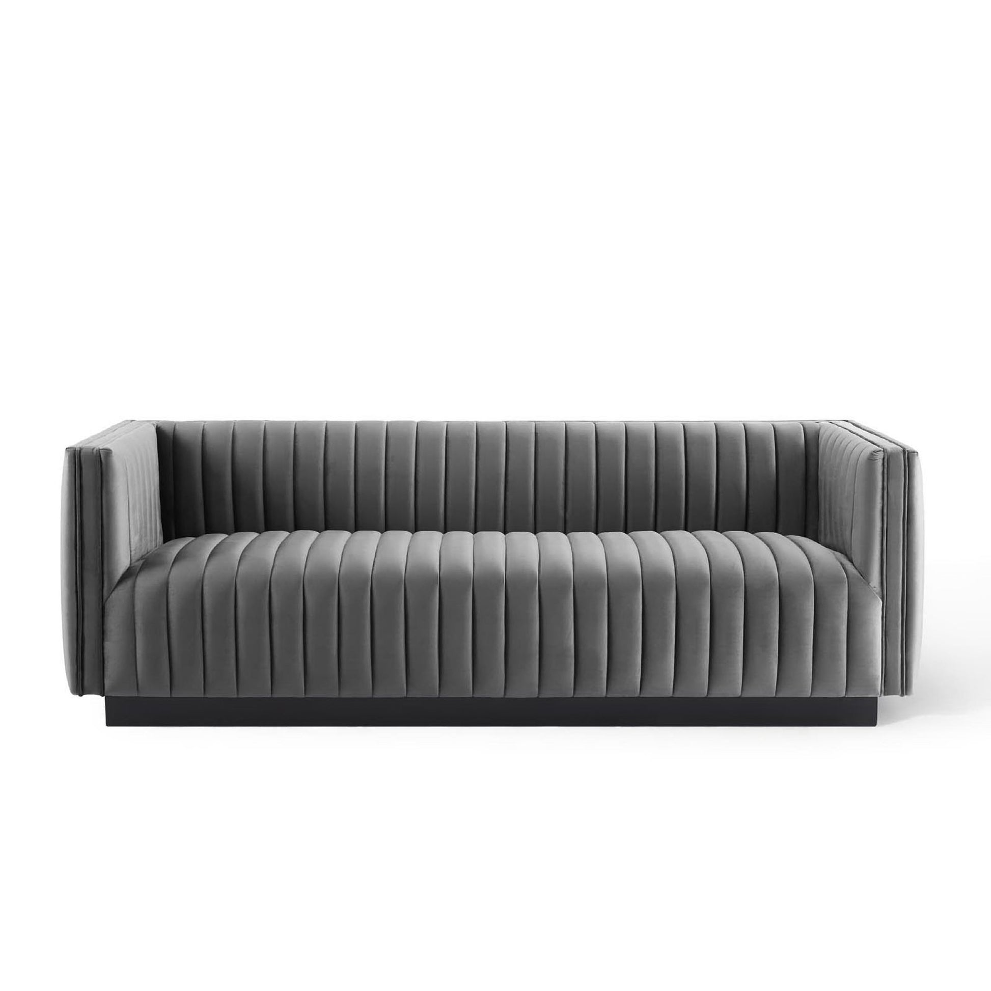 Grey velvet sofa with vertical channel tufting, low-profile arms and sleek contemporary lounge design.
