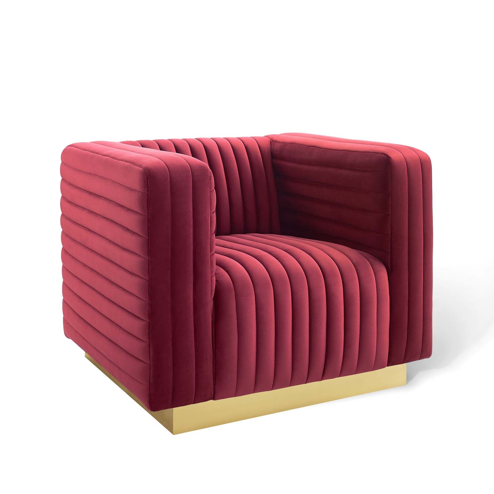 Maroon velvet upholstered armchair with vertical channel tufting on all sides and a gold metal base.