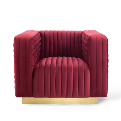 Maroon velvet channel-tufted armchair with gold base, modern luxe seating.