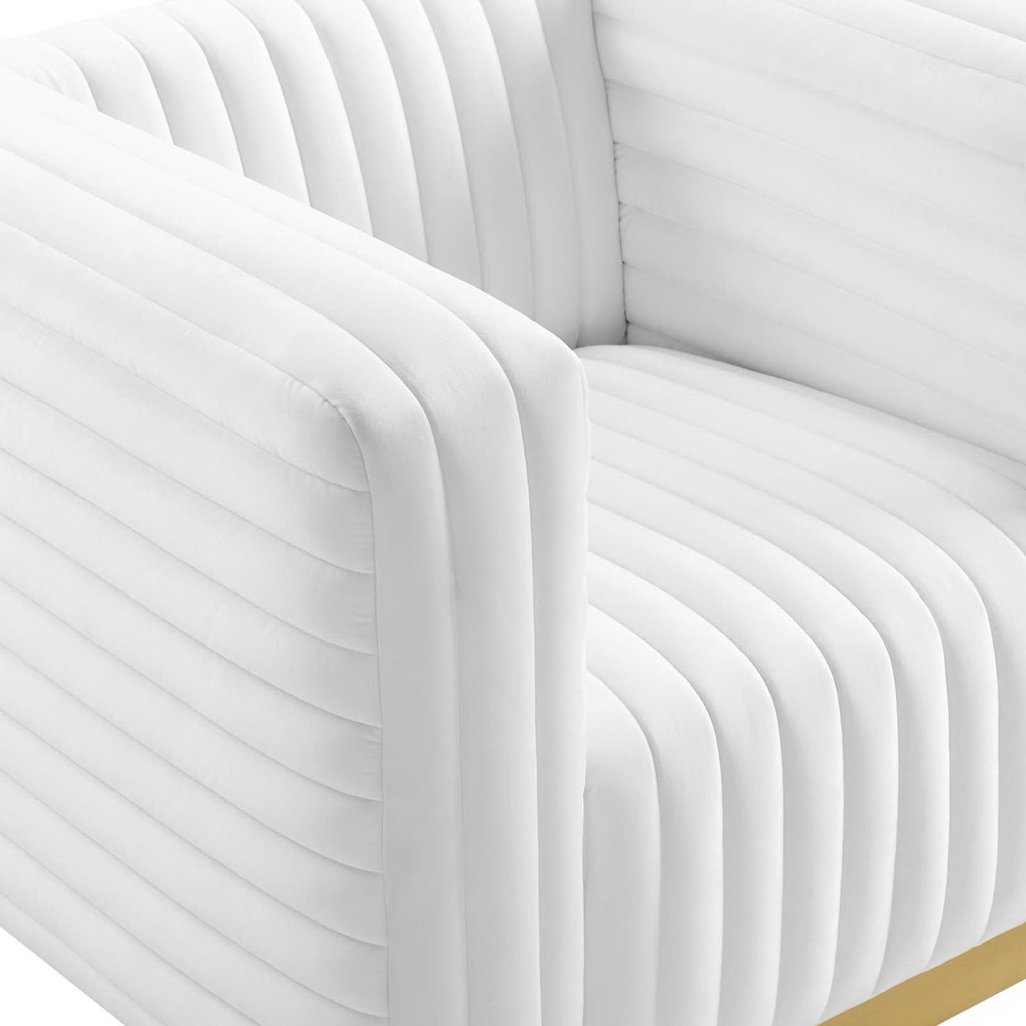 White upholstered accent armchair with rounded arms and vertical channel tufting, modern contemporary design.