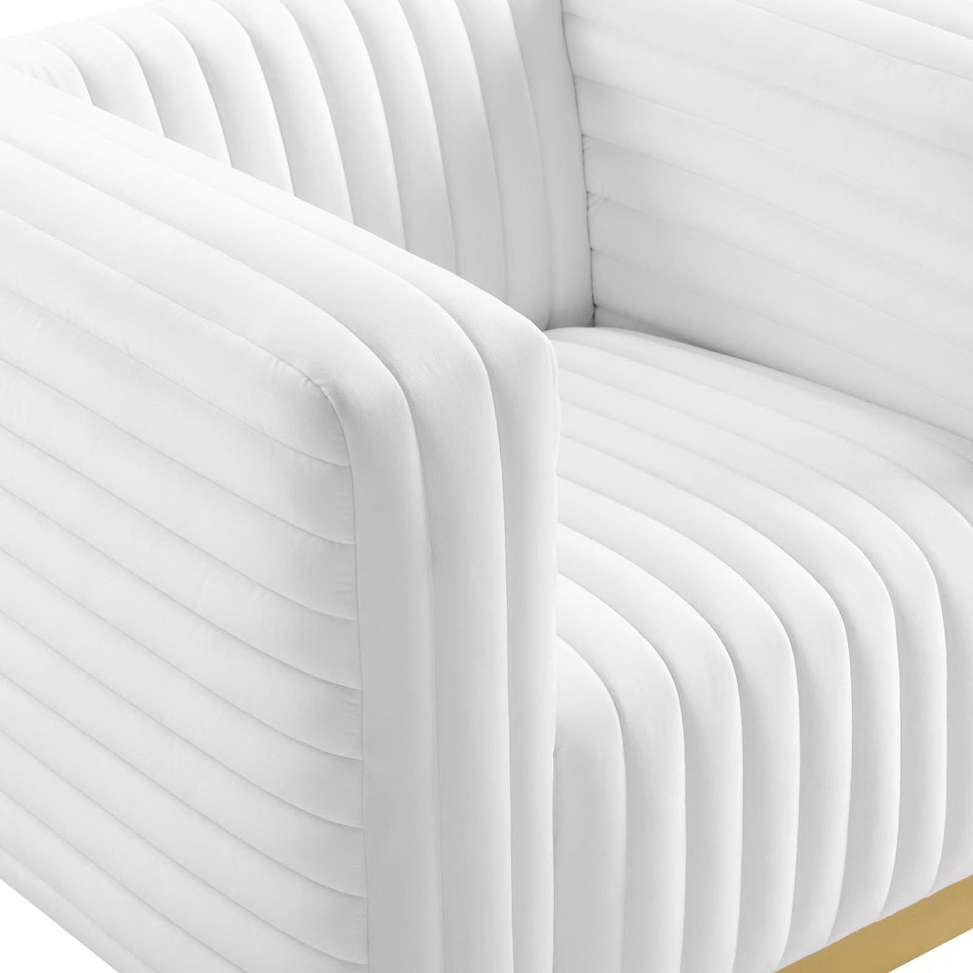 White upholstered accent armchair with rounded arms and vertical channel tufting, modern contemporary design.