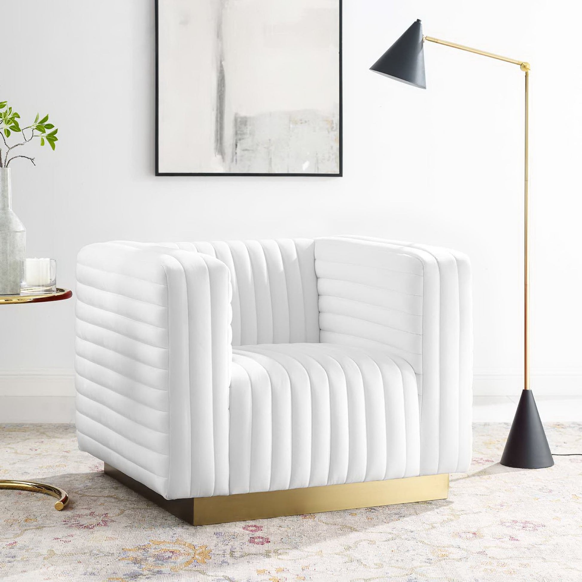 White ribbed armchair with gold metal base, modern living room scene; gold floor lamp with black shade.
