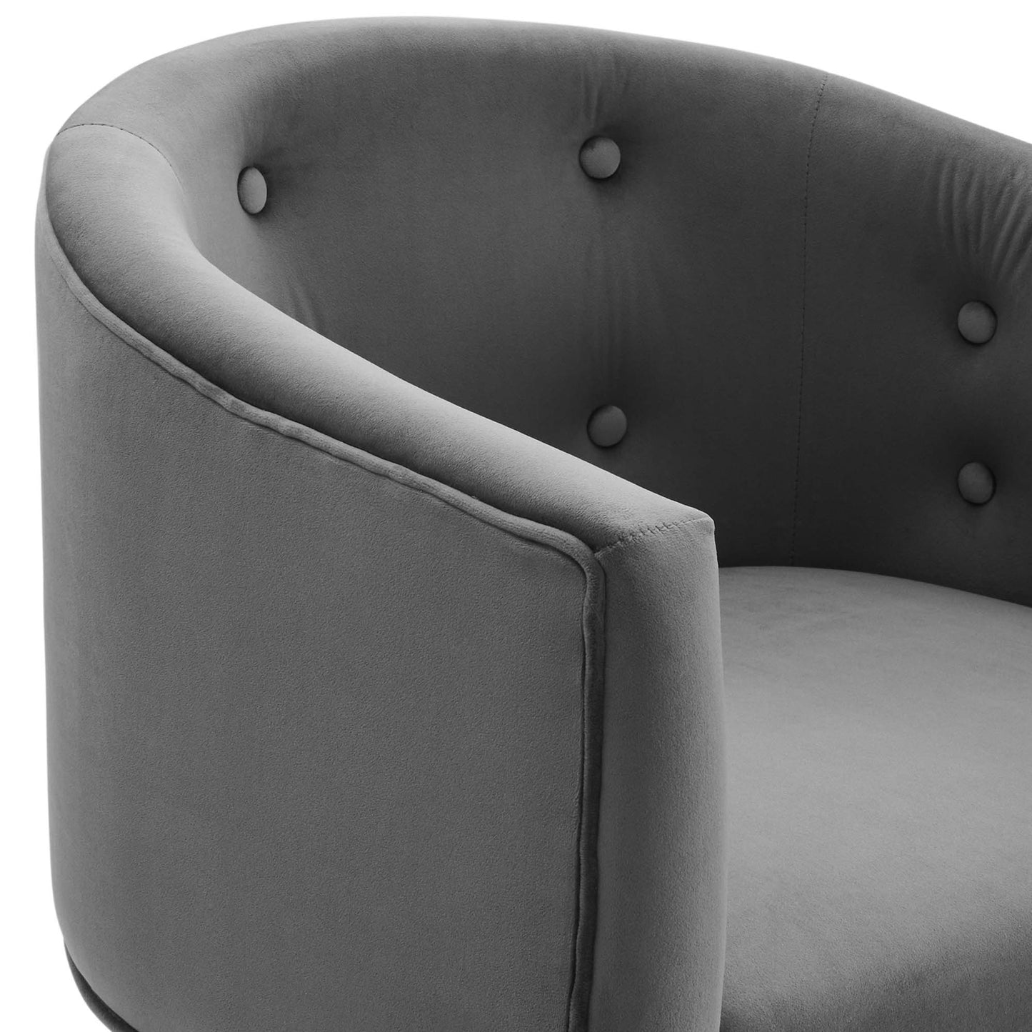 Grey curved fabric armchair with button-tufted back and cushioned seat.