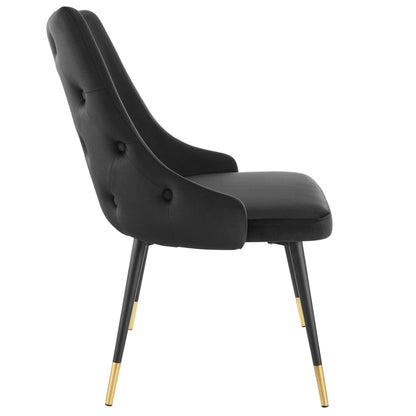 Black upholstered mid-century curved-back chair with button tufting and gold-tipped legs.