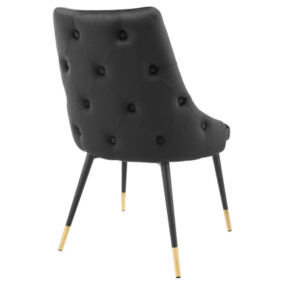 Black tufted performance velvet dining side chair with curved back and gold-tipped legs.