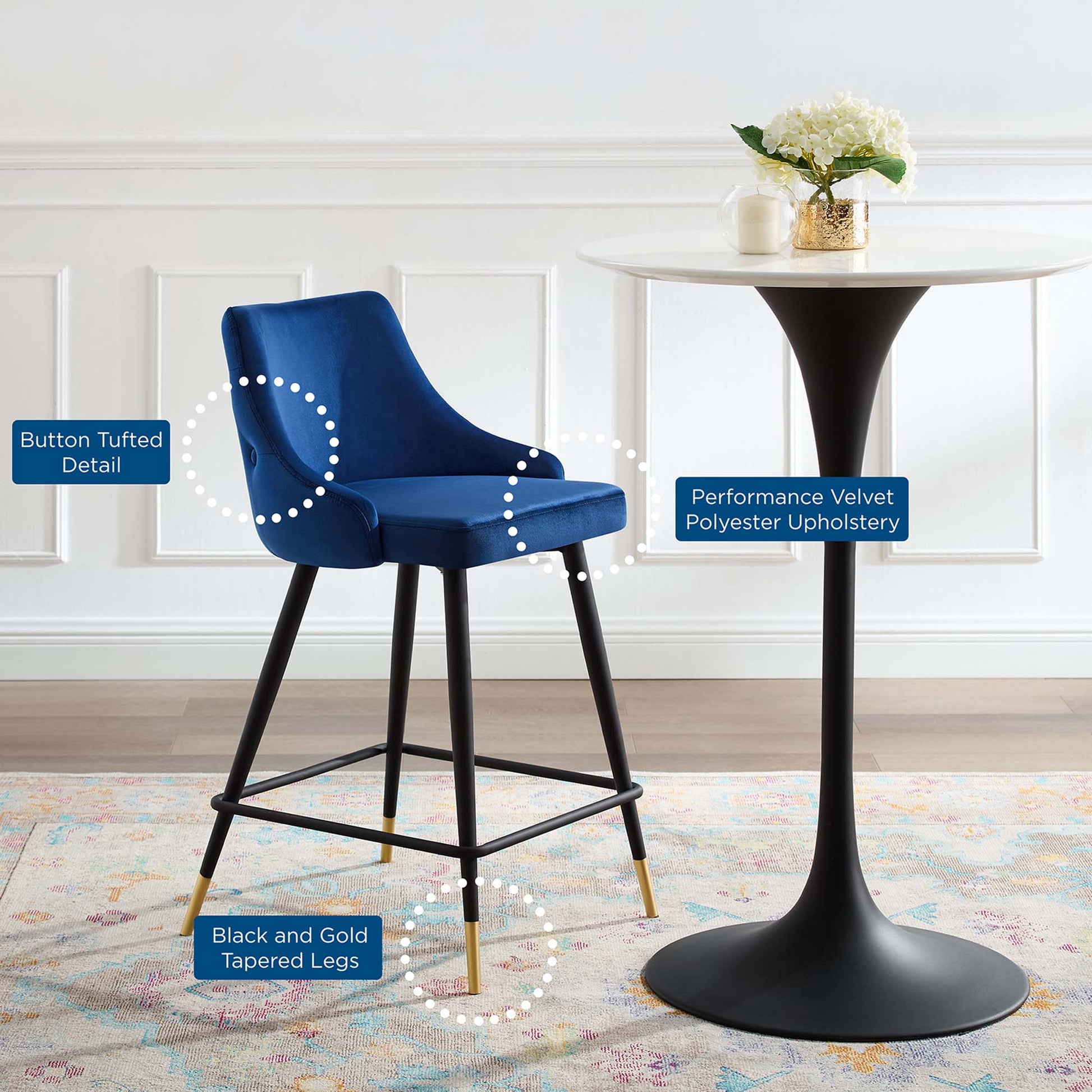 Navy performance velvet polyester upholstery counter stool with button tufted detail and black and gold tapered legs.