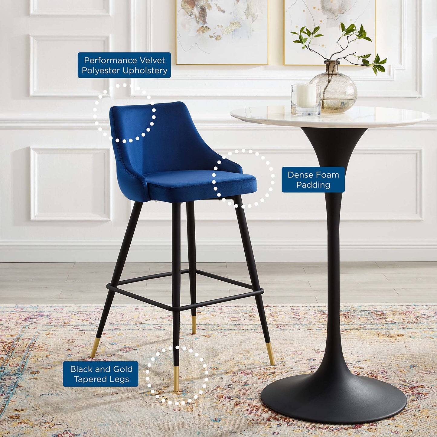 Navy velvet bar stool with performance velvet upholstery, dense foam padding, and black tapered legs with gold tips.