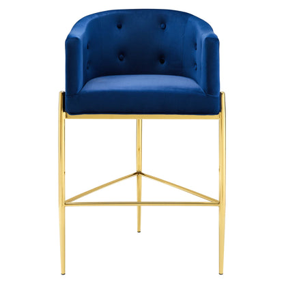 Navy velvet tufted bar stool with gold metal frame, curved back, and footrest.