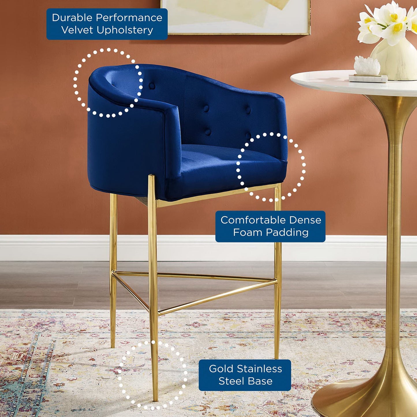 Navy tufted performance velvet bar stool with a padded back and seat on a gold metal base.
