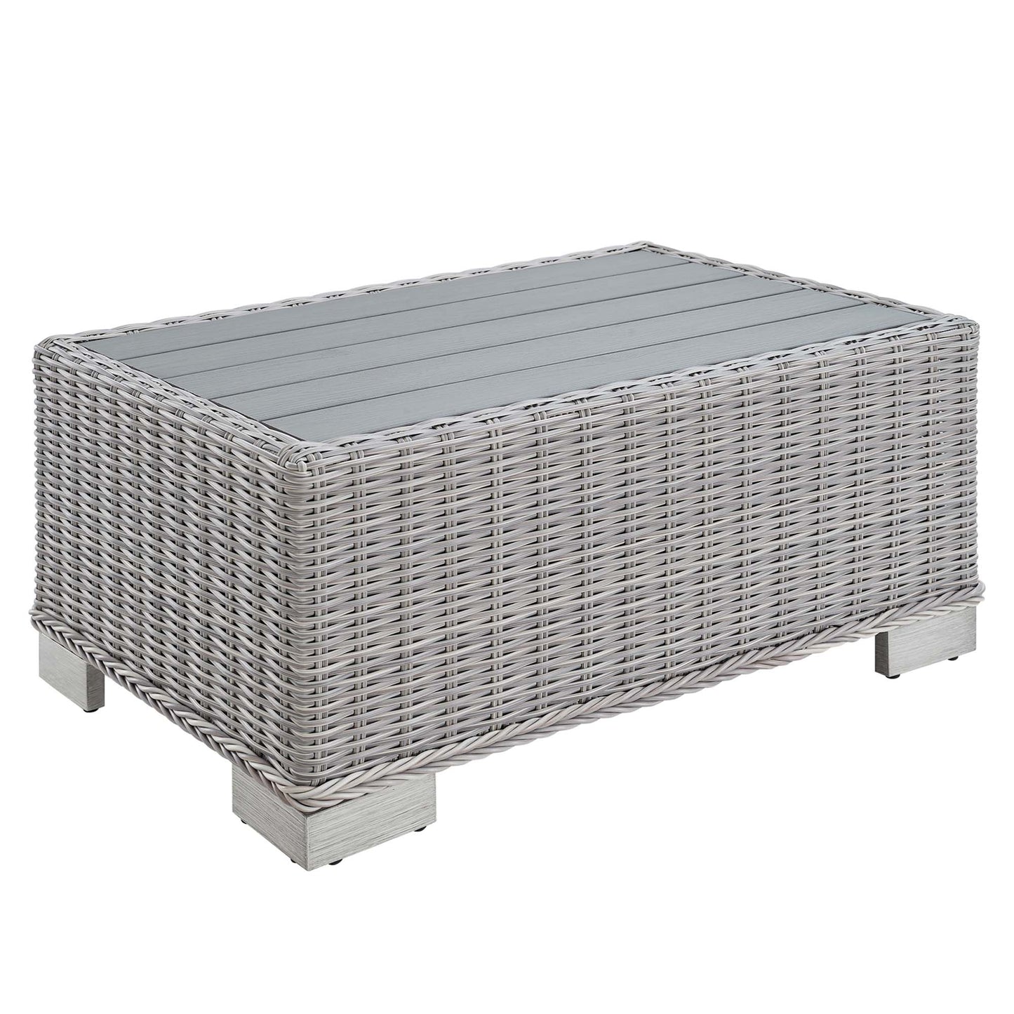 Rectangular gray wicker coffee table with glass top and short square metal legs.