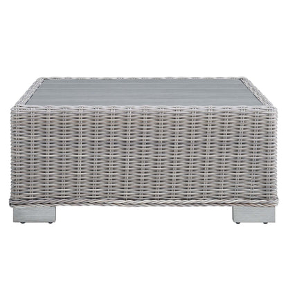 Rectangular light gray wicker coffee table with glass top, woven rattan style for outdoor patio use.