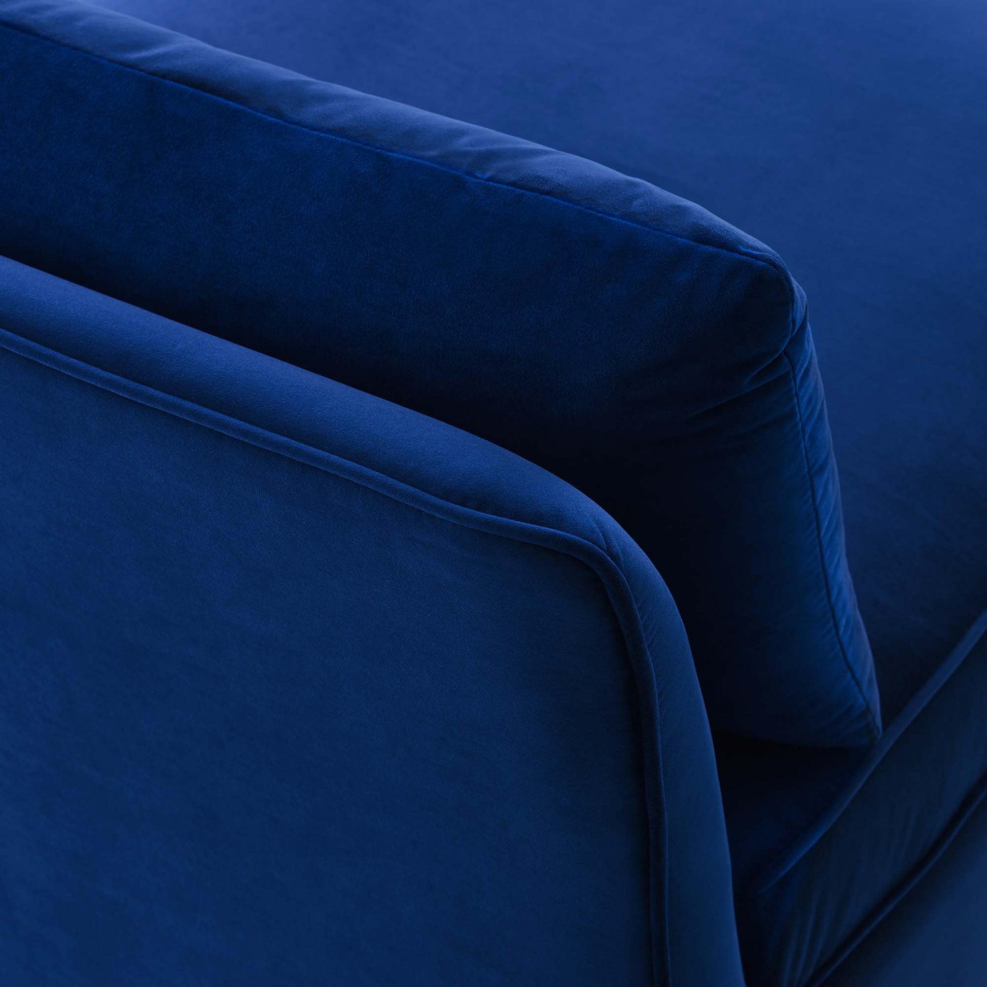 Navy blue velvet armless chair close-up of plush cushions.