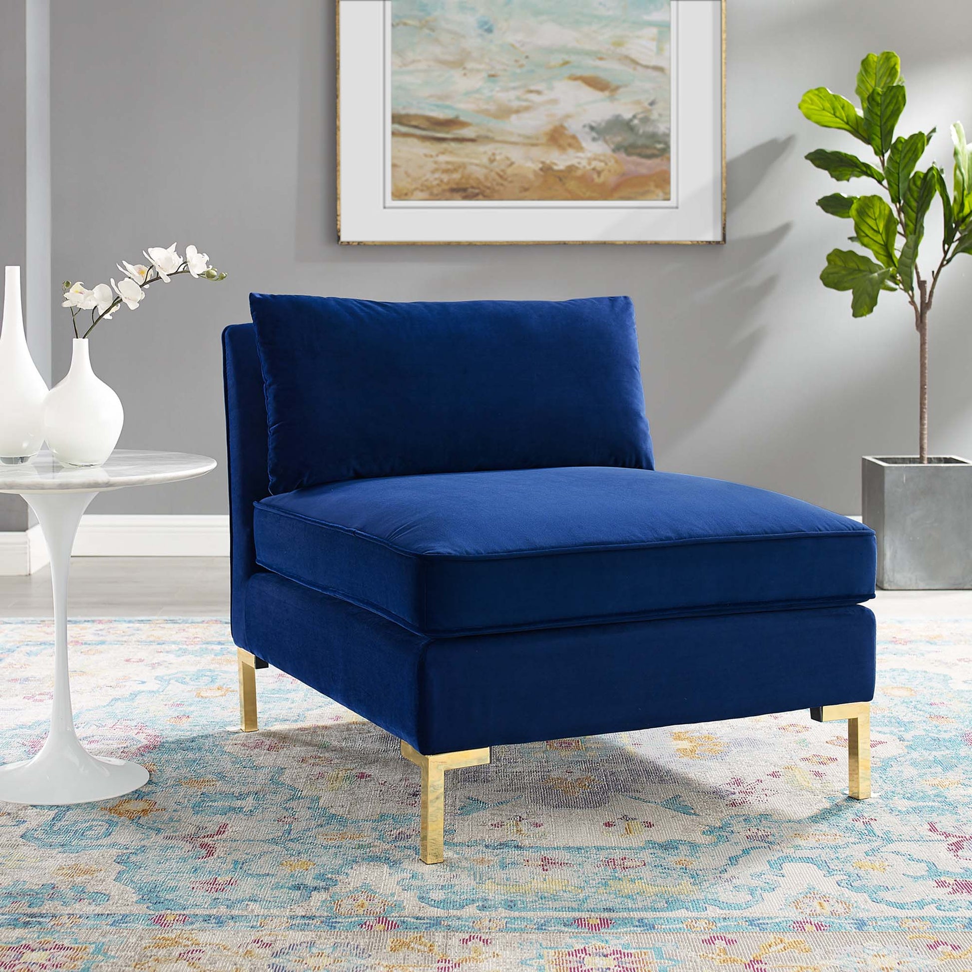 Navy blue performance velvet armless chair with square cushions & gold metal legs, modern glam living room accent.