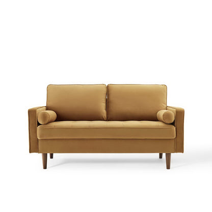 Brown velvet loveseat with two back cushions and cylindrical bolster pillows, square arms, and tapered wood legs.