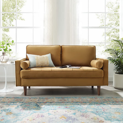 Brown velvet loveseat with two-seat design and tapered legs in a bright living room.