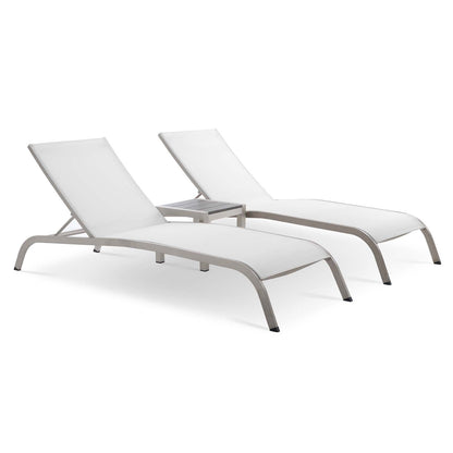 Two white outdoor chaise lounges with light gray metal frames and a shared small side table.
