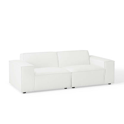 White faux leather sofa with square arms, two-seat cushions, and short black legs.