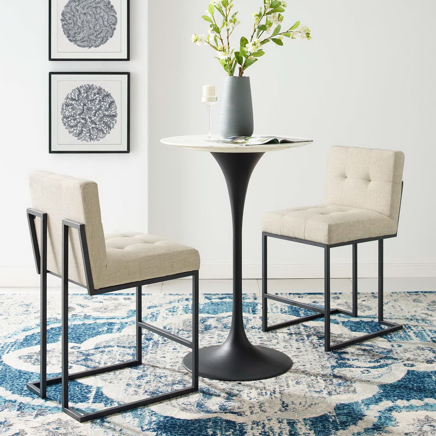 Set of 2 counter stools with oatmeal fabric upholstery and black stainless steel frames.
