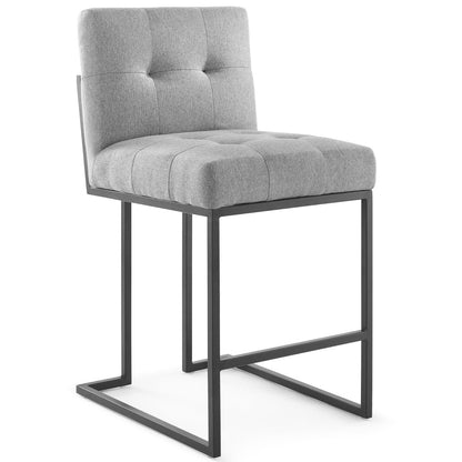 Grey tufted fabric bar stool with black metal sled frame and cushioned backrest.