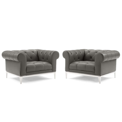 Pair of gray tufted leather armchairs with chrome metal legs, Chesterfield-style lounge seating.