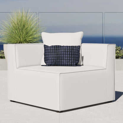 White outdoor modular sectional sofa corner chair with square arms & thick cushions, accented by a navy geometric throw pillow.