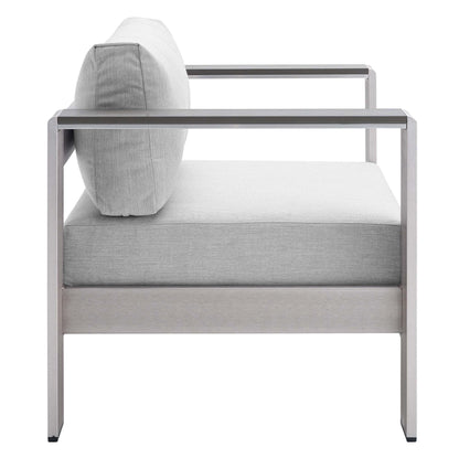 Modern silver aluminum outdoor patio armchair with light slate gray cushions and a matching back pillow.
