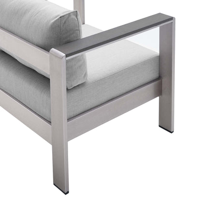 Modern silver-gray metal frame chair with light gray cushions and square arms.