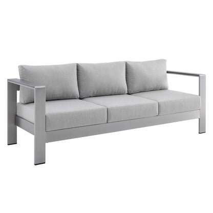 Slate gray outdoor sofa with an aluminum frame, three seat cushions and three back cushions, straight square arms.