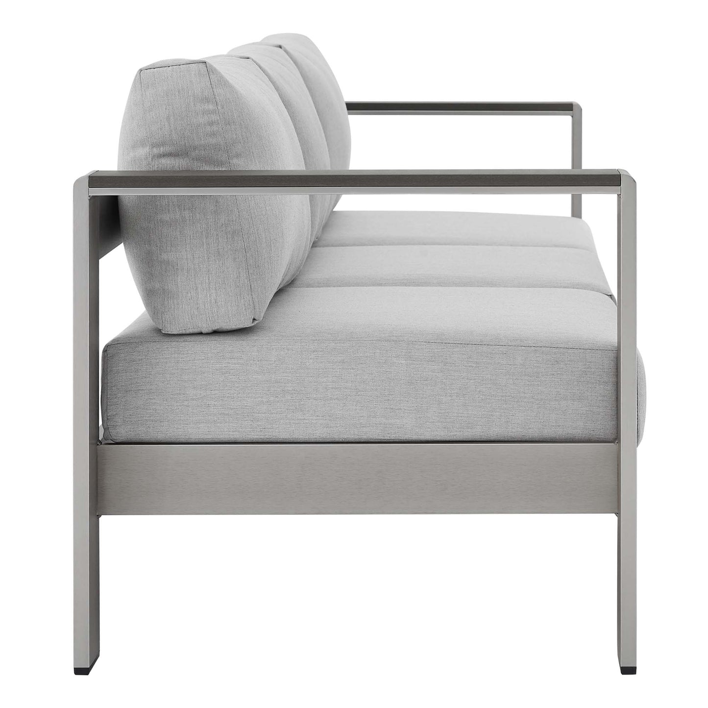 Modern gray outdoor patio sofa with an aluminum frame, light gray cushions, straight arms, side view.
