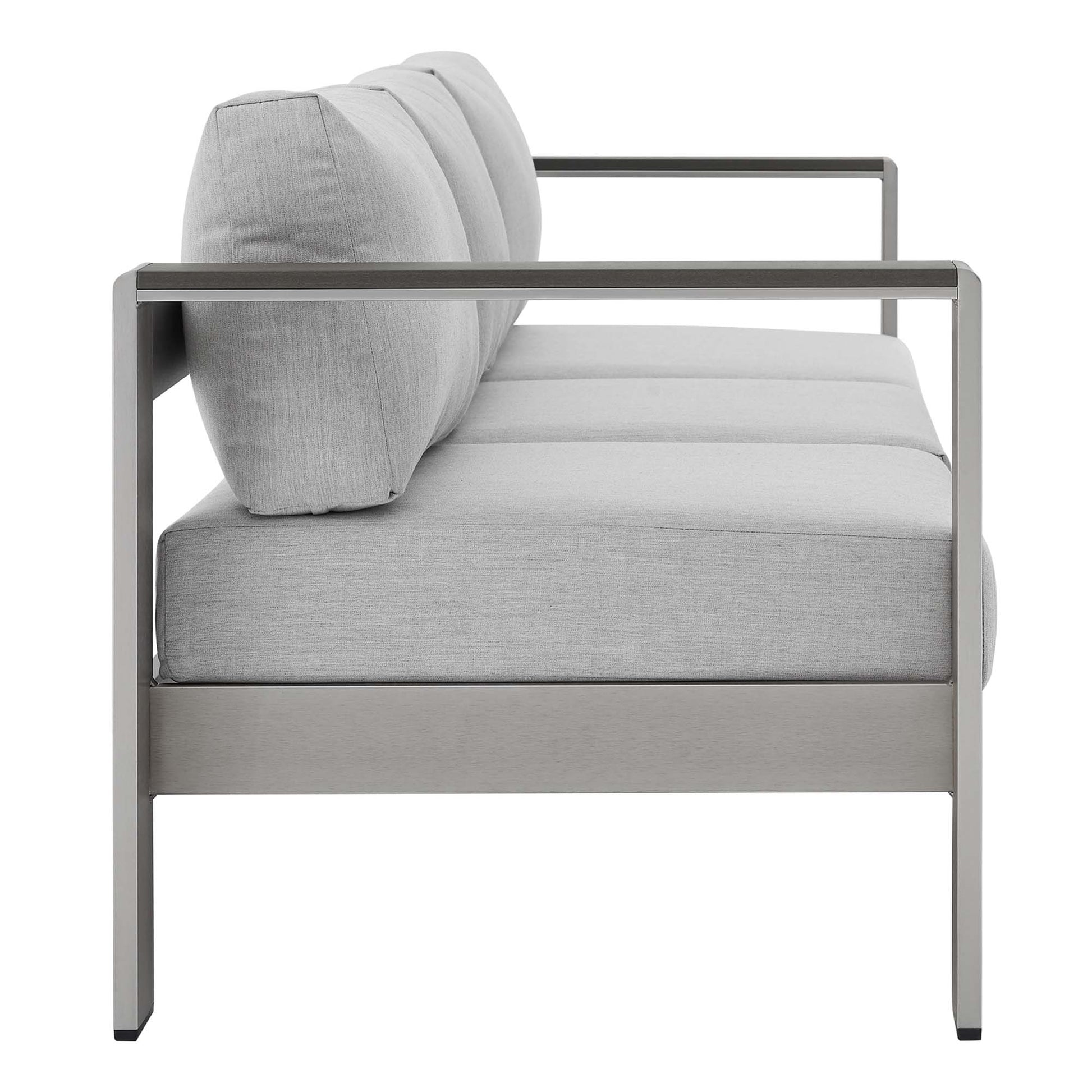 Modern gray outdoor patio sofa with an aluminum frame, light gray cushions, straight arms, side view.