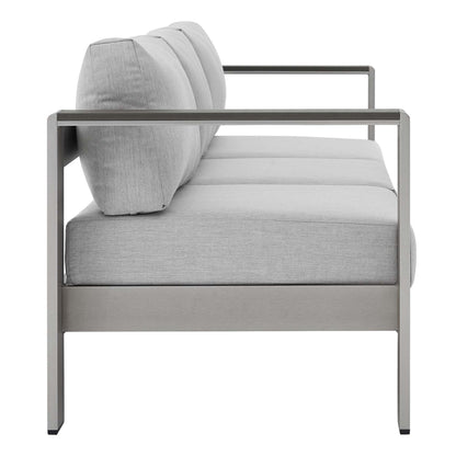 Modern gray outdoor patio sofa with an aluminum frame, light gray cushions, straight arms, side view.