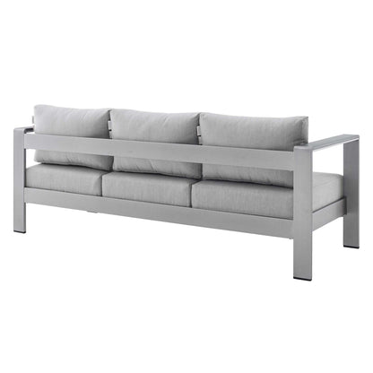 Slate gray modern sofa with a boxy metal frame and three-seat cushions with matching back pillows.