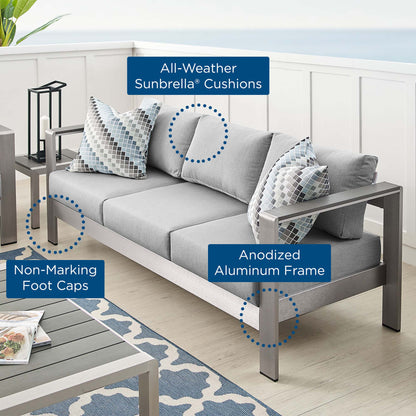 Outdoor gray sofa with anodized aluminum frame, all-weather Sunbrella cushions, and non-marking foot caps.