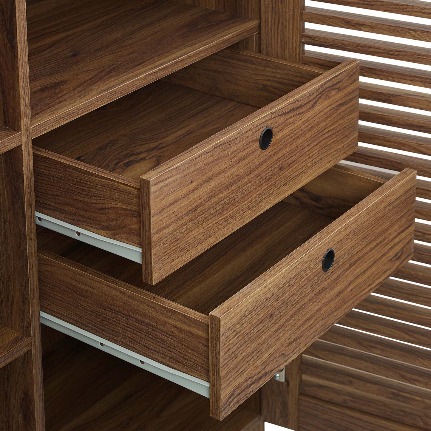 Walnut-finish wooden bar cabinet with three drawers and circular cut-out pulls, slatted sides.