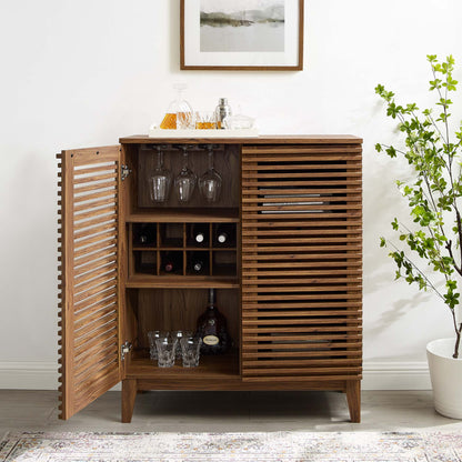 Walnut wood bar cabinet with slatted doors; left cabinet holds wine glasses and bottles, with decanters on top.