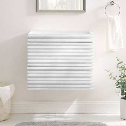 White square wall-mount bathroom vanity cabinet with slatted doors and horizontal grooves in a bright bathroom.