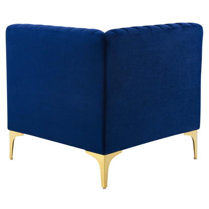 Navy velvet loveseat with channel tufting, gold metal legs, mid-century modern style.