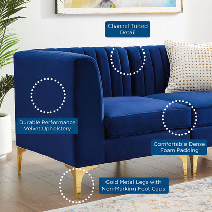 Navy velvet loveseat with channel tufting, dense foam padding, gold metal legs, non-marking caps, and a dotted accent pillow.