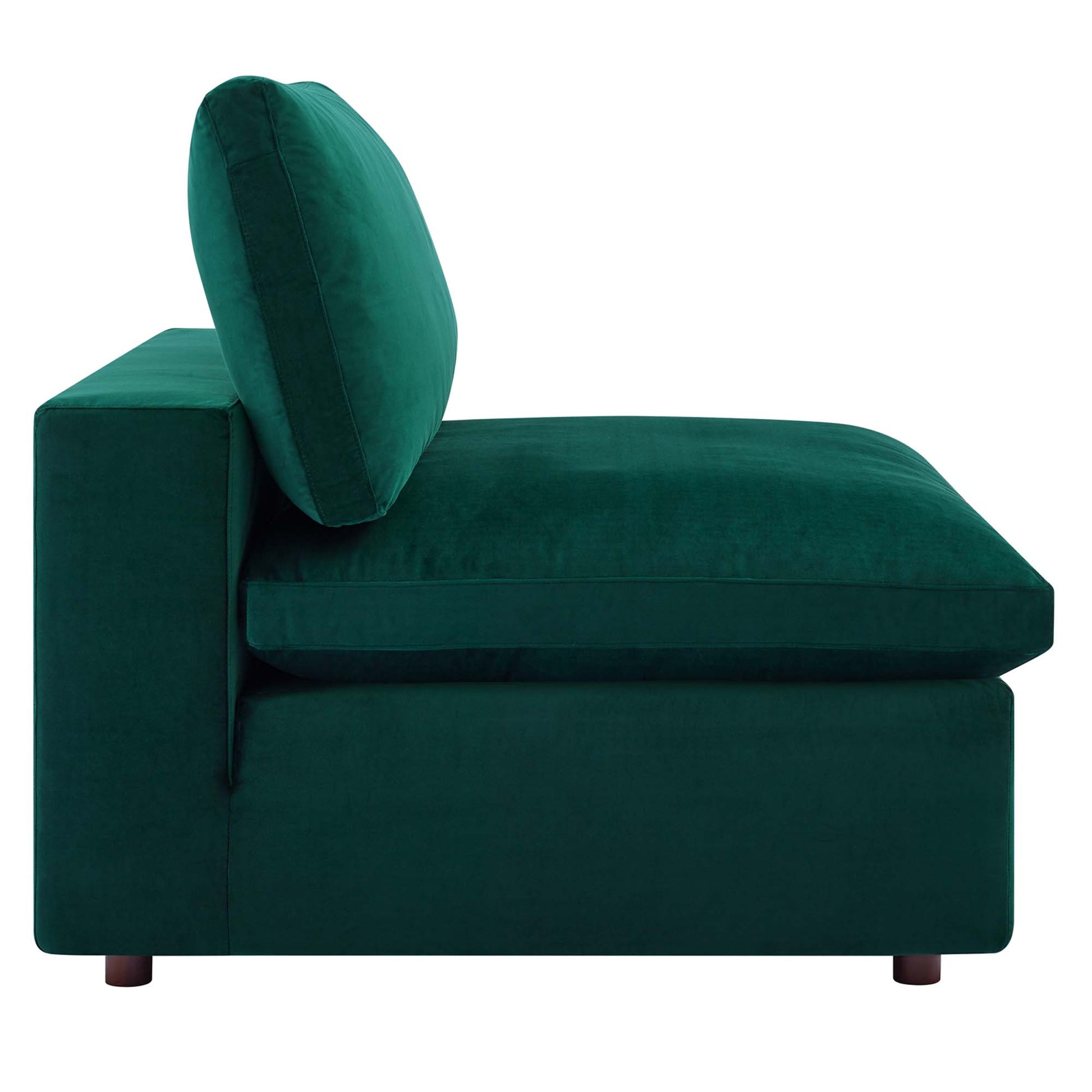 Emerald green velvet armless chair with thick cushions and short wooden legs.