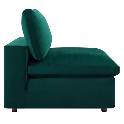 Emerald green velvet armless chair with thick cushions and short wooden legs.