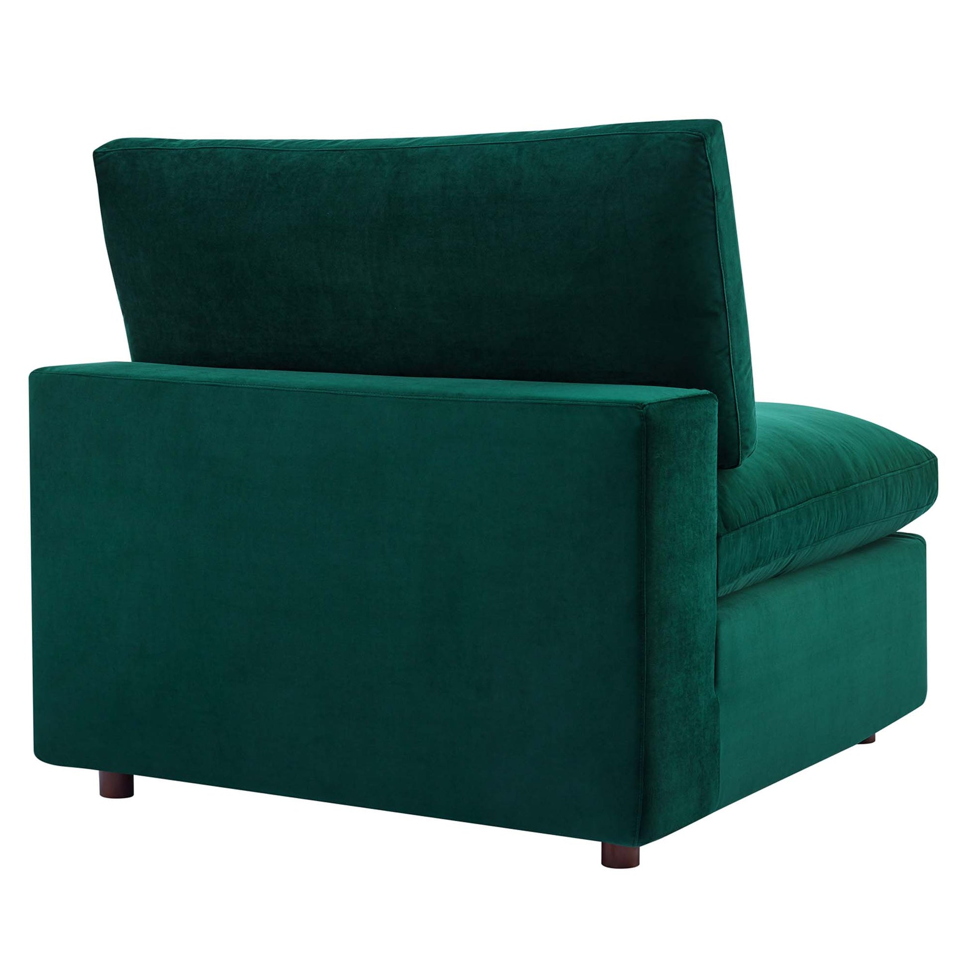 Emerald green velvet armless chair with thick cushion and short dark wood legs.