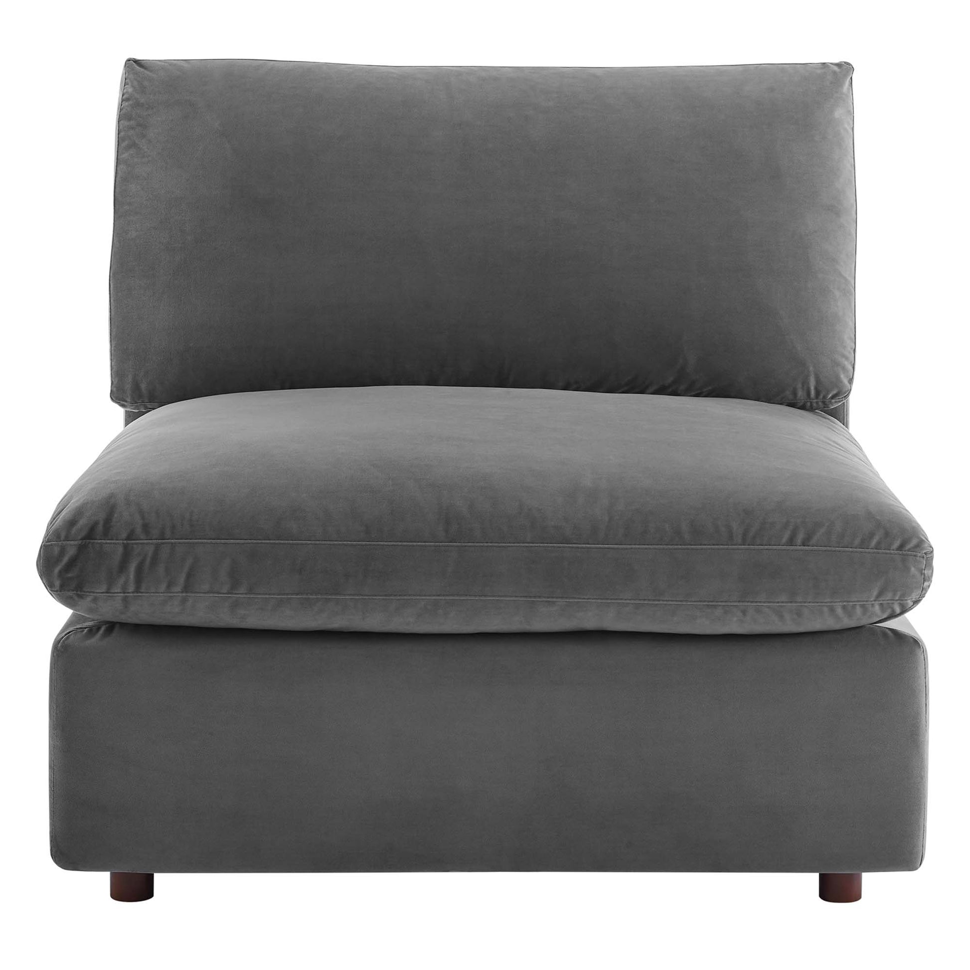 Grey velvet armless chair with thick seat and back cushions, low-profile with short wooden legs.