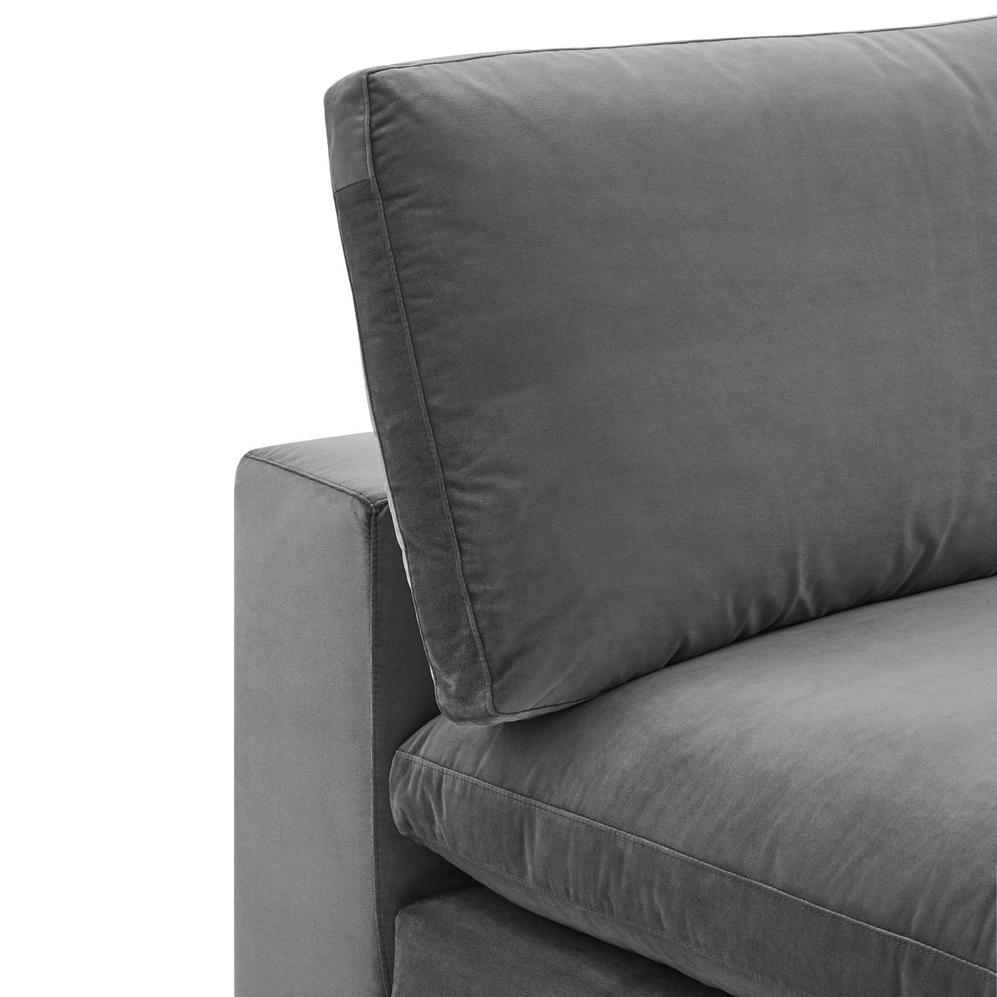 Gray velvet armless chair with plush, overstuffed cushions; close-up view.