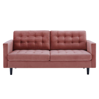 Dusty rose velvet sofa with tufted back cushions, square arms, two-seat design, black tapered legs, mid-century style.
