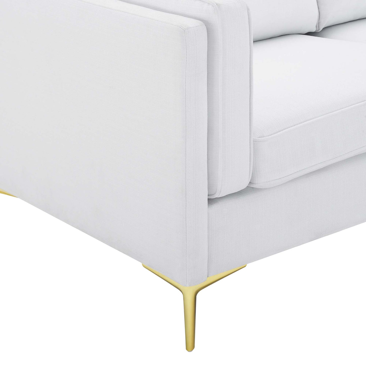 White fabric sofa with slender gold legs and plush cushions, mid-century style.