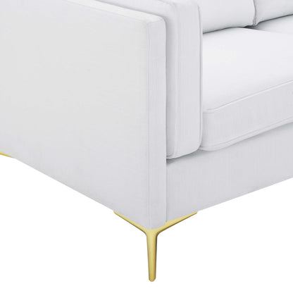 White fabric sofa with slender gold legs and plush cushions, mid-century style.