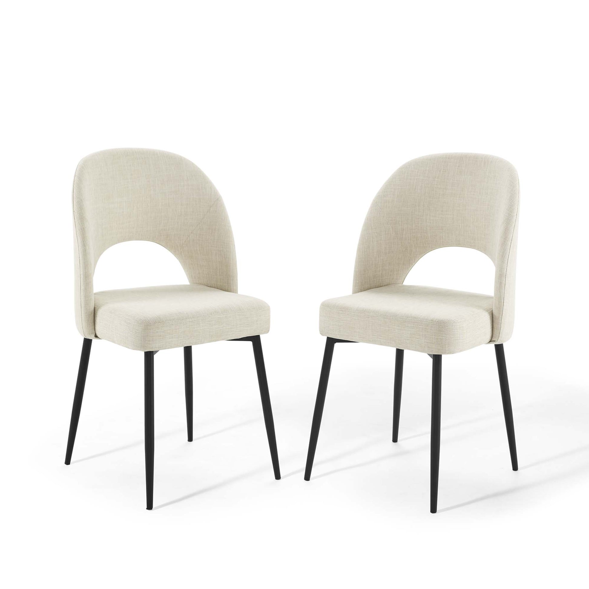 Pair of beige fabric dining chairs with curved backrest and cutout, black tapered metal legs.