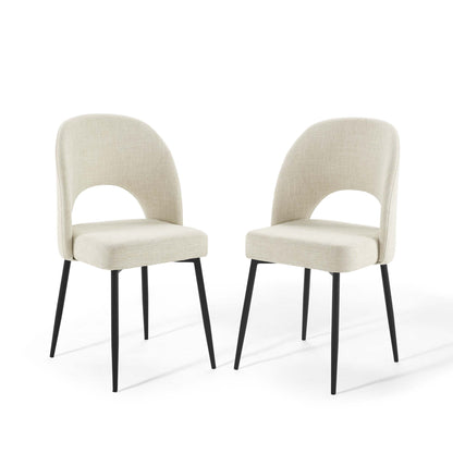 Pair of beige fabric dining chairs with curved backrest and cutout, black tapered metal legs.